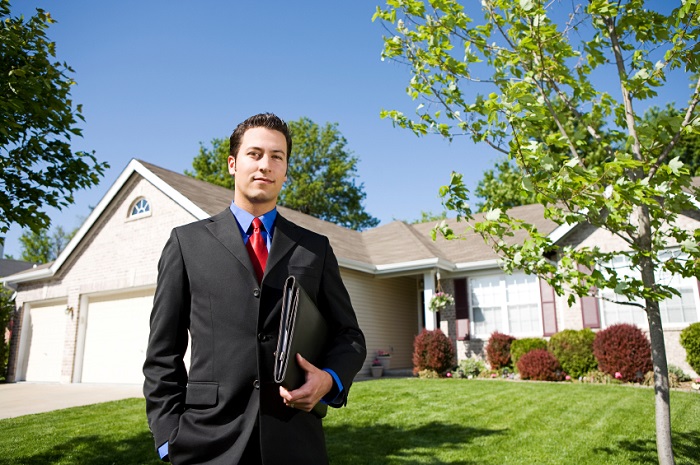 real estate agent in front of a house