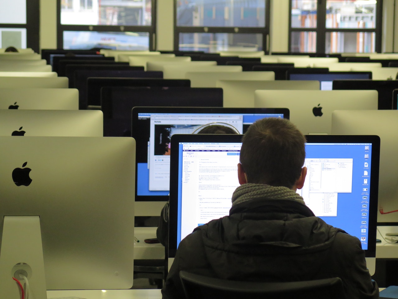 a man using a computer inside a classroom